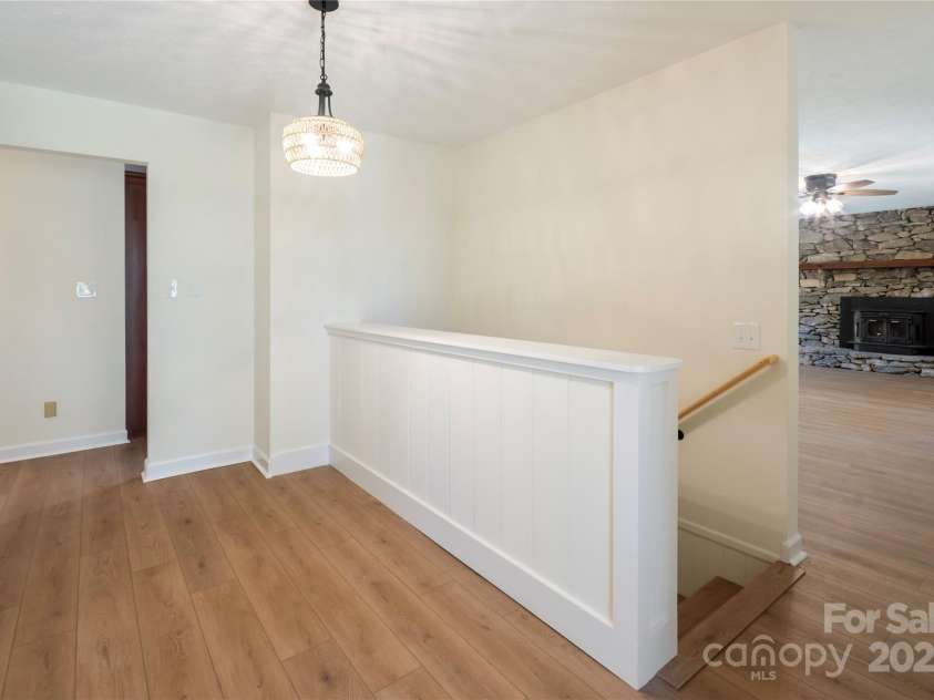 90 Joe Jenkins Road, Fairview, NC 28730.  MLS# CAR4288516, YatesRealty ID 12466. The home boasts a spacious and inviting entry area, immediately creating a welcoming atmosphere for visitors and setting a positive tone for the entire property.