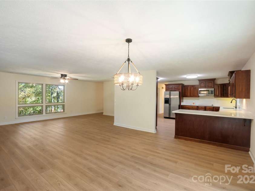 90 Joe Jenkins Road, Fairview, NC 28730.  MLS# CAR4288516, YatesRealty ID 12466. This home features a light, bright, and comfortable guest bedroom, perfect for overnight visitors. The room is designed to provide a relaxing and welcoming space, ensuring a pleasant stay for guests.