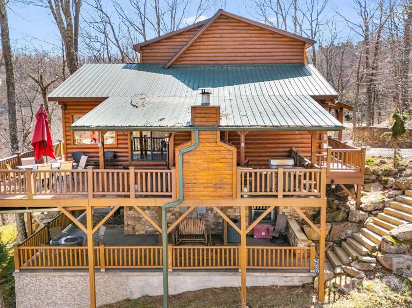 100 Flame Azalea Lane, Mars Hill, NC 28754.  MLS# CAR4248115, YatesRealty ID 12470. A stunning side perspective reveals both stories of covered outdoor living, with a stone stairwell providing easy access to the driveway.