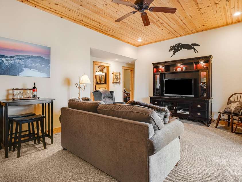 100 Flame Azalea Lane, Mars Hill, NC 28754.  MLS# CAR4248115, YatesRealty ID 12470. Basement entertainment room.