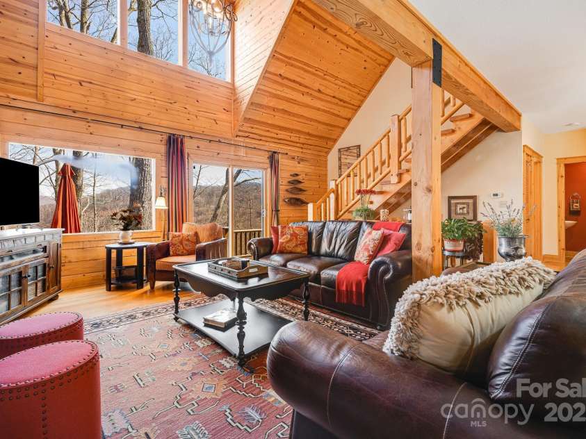 100 Flame Azalea Lane, Mars Hill, NC 28754.  MLS# CAR4248115, YatesRealty ID 12470. Beautiful natural light from the wall of windows in the vaulted living room.