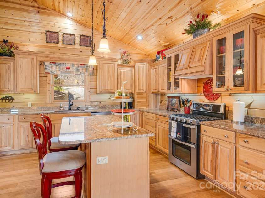 100 Flame Azalea Lane, Mars Hill, NC 28754.  MLS# CAR4248115, YatesRealty ID 12470. Island prep station with extra seating & storage.