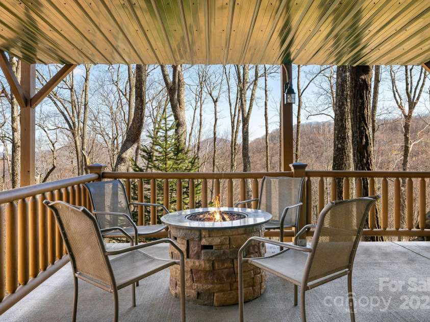100 Flame Azalea Lane, Mars Hill, NC 28754.  MLS# CAR4248115, YatesRealty ID 12470. Lower level gas fire pit seating.