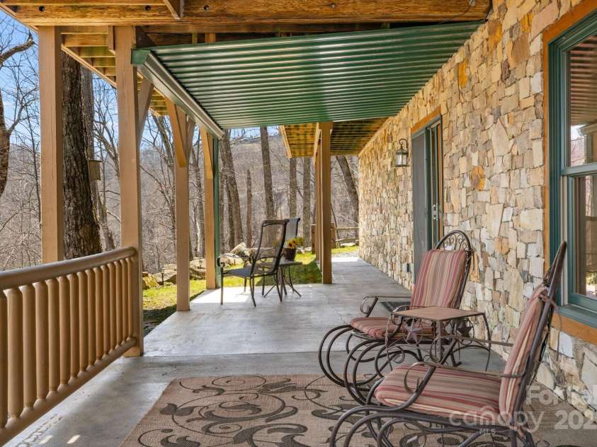 100 Flame Azalea Lane, Mars Hill, NC 28754.  MLS# CAR4248115, YatesRealty ID 12470. Lower level patio from the basement living room.
