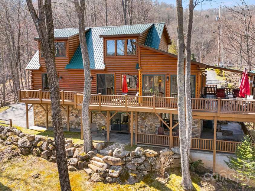 100 Flame Azalea Lane, Mars Hill, NC 28754.  MLS# CAR4248115, YatesRealty ID 12470. Rear view of 100 Flame Alazela showcasing the outdoor wrap around decking and seating areas.