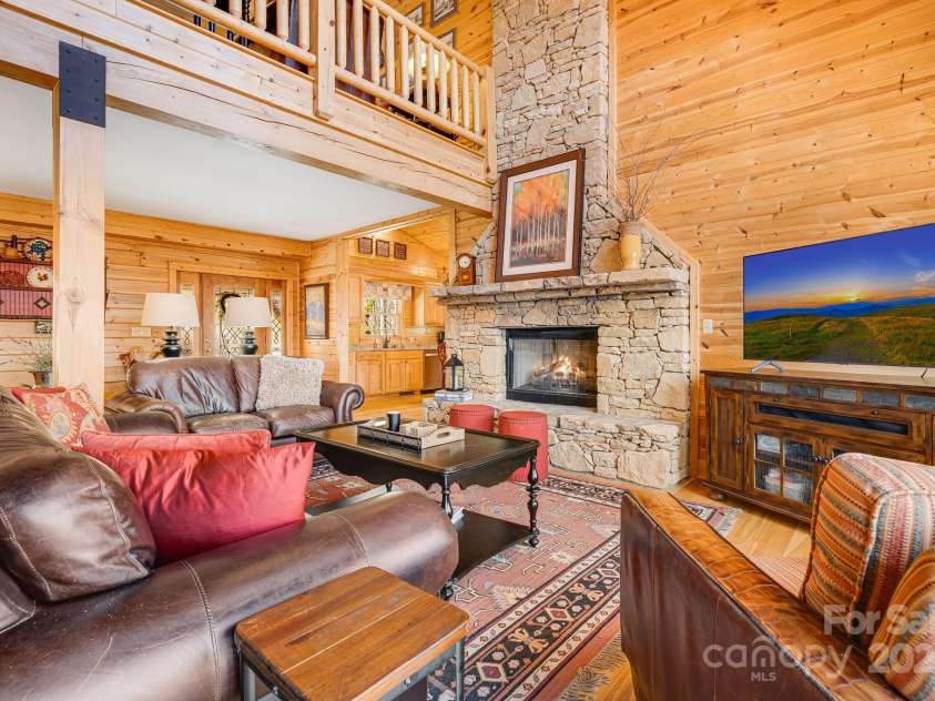100 Flame Azalea Lane, Mars Hill, NC 28754.  MLS# CAR4248115, YatesRealty ID 12470. Stone fireplace with gas logs will keep you warm during the cooler temperatures.