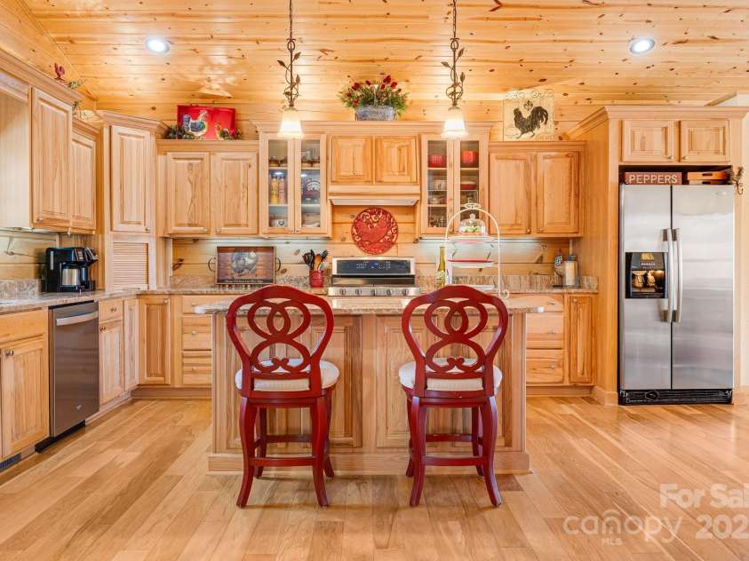 100 Flame Azalea Lane, Mars Hill, NC 28754.  MLS# CAR4248115, YatesRealty ID 12470. This chef’s kitchen offers granite surfaces, custom cabinetry, and ample storage — where form meets function in style.