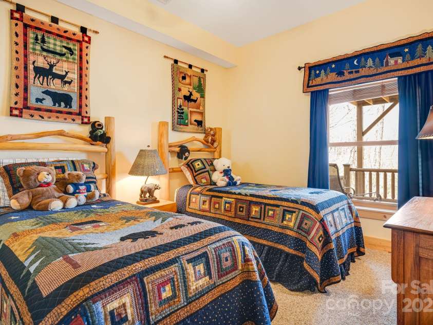 100 Flame Azalea Lane, Mars Hill, NC 28754.  MLS# CAR4248115, YatesRealty ID 12470. Welcome to the 'Cubs' bedroom: twin beds, a window to the mountains, and space to dream big.