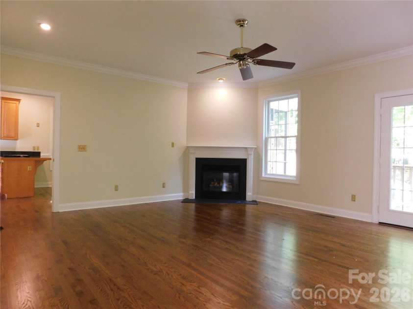 1064 Skye Drive, Pisgah Forest, NC 28768.  MLS# CAR4370821, YatesRealty ID 12470. Corner fireplace adds warmth and ambiance to main level living room.