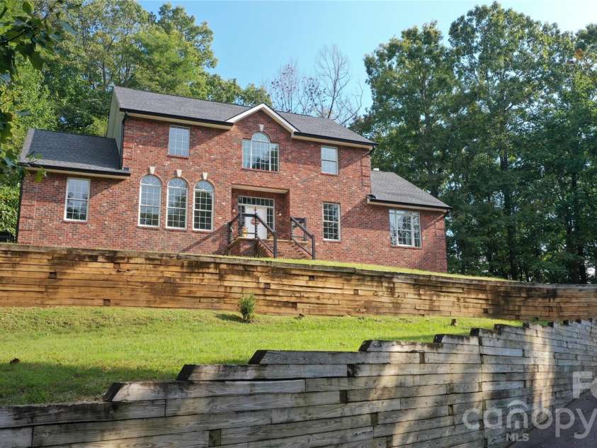 1064 Skye Drive, Pisgah Forest, NC 28768.  MLS# CAR4370821, YatesRealty ID 12470. Paved drive leads to 2-car garage.