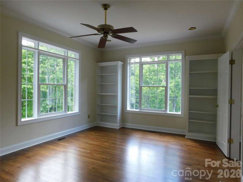 1064 Skye Drive, Pisgah Forest, NC 28768.  MLS# CAR4370821, YatesRealty ID 12470. Primary bedroom offers built-in bookcases for storage and display.