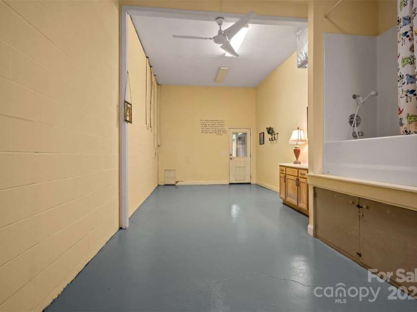 768 White Oak Lane, Tryon, NC 28782.  MLS# CAR4304996, YatesRealty ID 12472. Left side of Basement with Dog Washing Facility