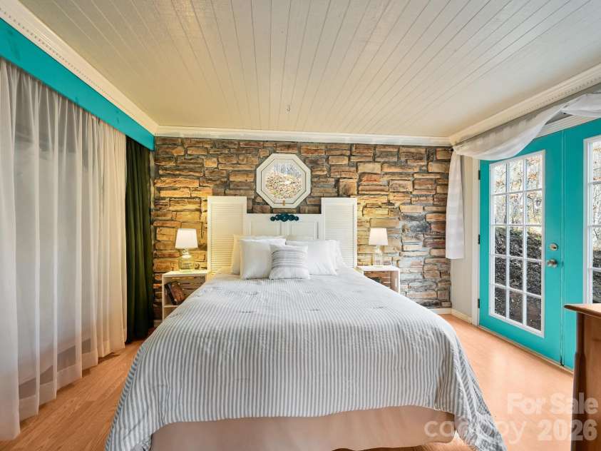 90 Davidson Gap Road, Leicester, NC 28748.  MLS# CAR4368699, YatesRealty ID 12474. Charming Stone Veneer Wall in Primary Bedroom