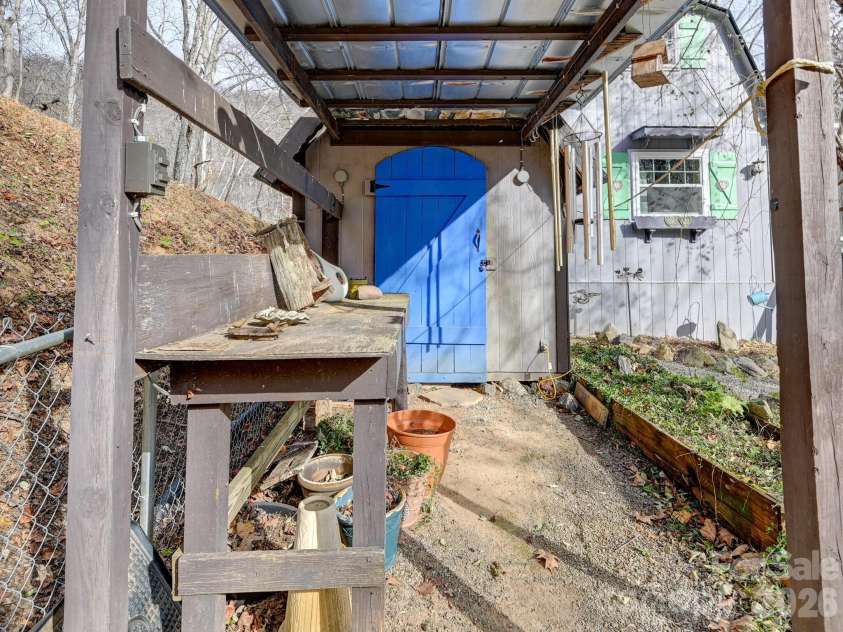 90 Davidson Gap Road, Leicester, NC 28748.  MLS# CAR4368699, YatesRealty ID 12474. Hobby/Workshop with Built-In Table and Electric