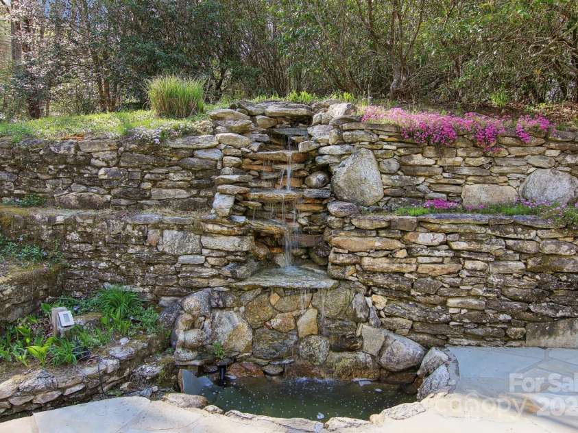 798 Evans Road, Hendersonville, NC 28739.  MLS# CAR4249023, YatesRealty ID 12477. Flagstone terrace w/water feature