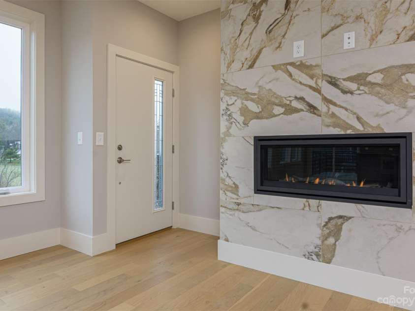33 Course Drive, Etowah, NC 28729.  MLS# CAR4069124, YatesRealty ID 1248. Front entrance door entering near gas fireplace