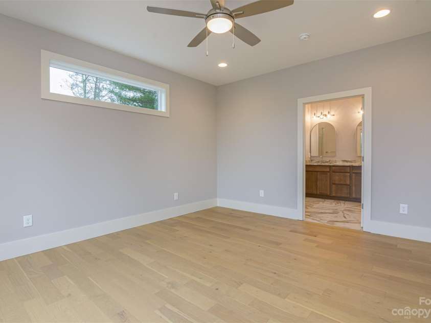 33 Course Drive, Etowah, NC 28729.  MLS# CAR4069124, YatesRealty ID 1248. Primary bedroom - transit window door to primary bathroom