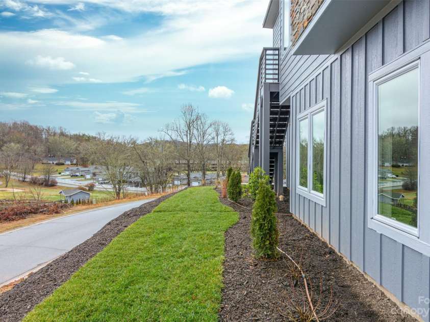 33 Course Drive, Etowah, NC 28729.  MLS# CAR4069124, YatesRealty ID 1248. Side view of home and N Course Drive