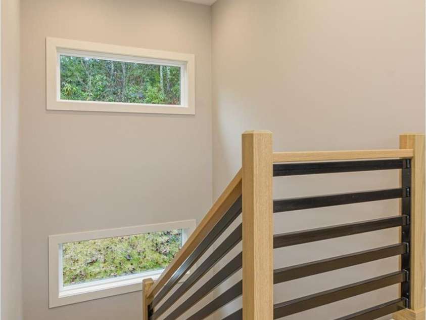 33 Course Drive, Etowah, NC 28729.  MLS# CAR4069124, YatesRealty ID 1248. Stairs leading to lower level - transit window light the way with beautiful views of the outdoors.