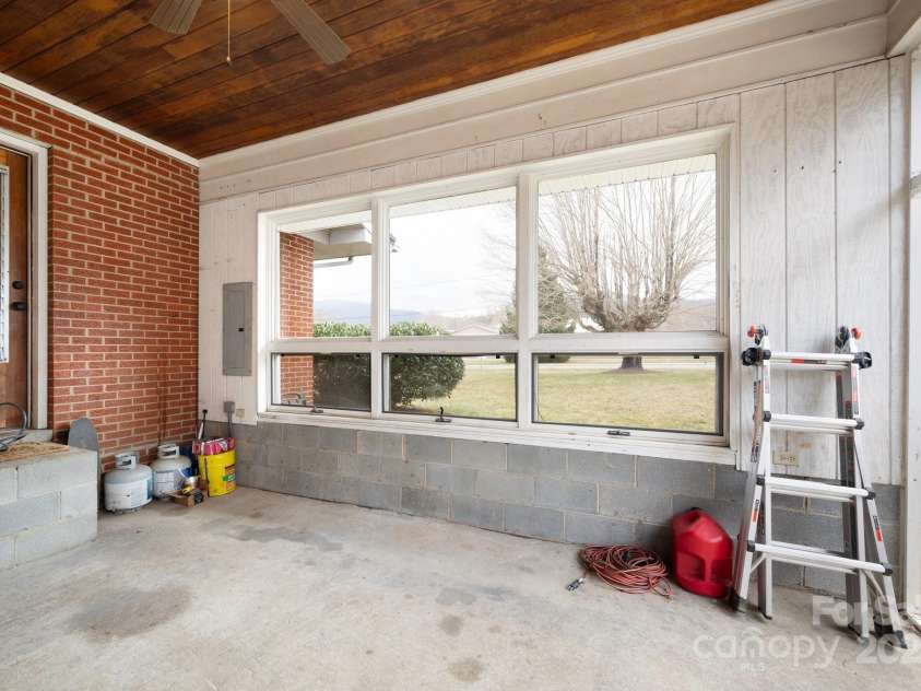 1134 Plott Creek Road, Waynesville, NC 28786.  MLS# CAR4221979, YatesRealty ID 12485. Side entry porch area that one may make into an extra room.