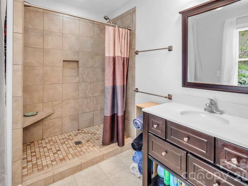 138 Uwharrie Court, Mount Gilead, NC 27306.  MLS# CAR4369880, YatesRealty ID 12486. Primary bathroom with tile shower.