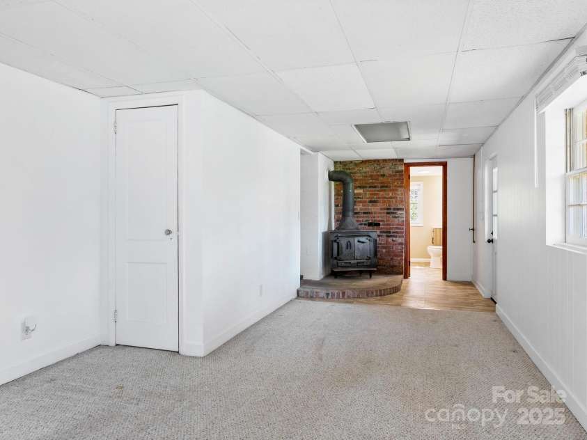 126 Big Oak Drive, Mills River, NC 28759.  MLS# CAR4240042, YatesRealty ID 12488. Lower level bonus room with woodburning fireplace