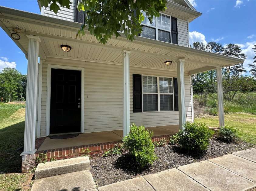 1300 Braveheart Lane, Charlotte, NC 28216.  MLS# CAR4255685, YatesRealty ID 12496. Great farmers porch welcomes you
