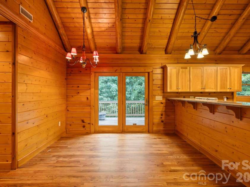 266 Rhododendron Drive, Saluda, NC 28773.  MLS# CAR4367080, YatesRealty ID 12496. Dining space with direct access to the deck through glass doors, bringing in natural light and easy indoor-outdoor living.