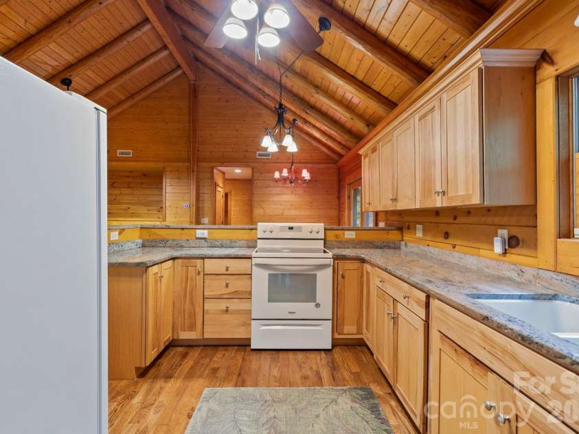 266 Rhododendron Drive, Saluda, NC 28773.  MLS# CAR4367080, YatesRealty ID 12496. Well-appointed kitchen with granite countertops, ample cabinetry, and a functional layout designed for efficiency.