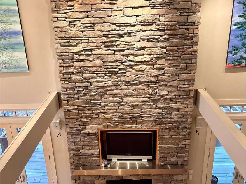 167 Trails End, Lake Lure, NC 28746.  MLS# CAR4245504, YatesRealty ID 12515. Beautiful 2-story stone FP.