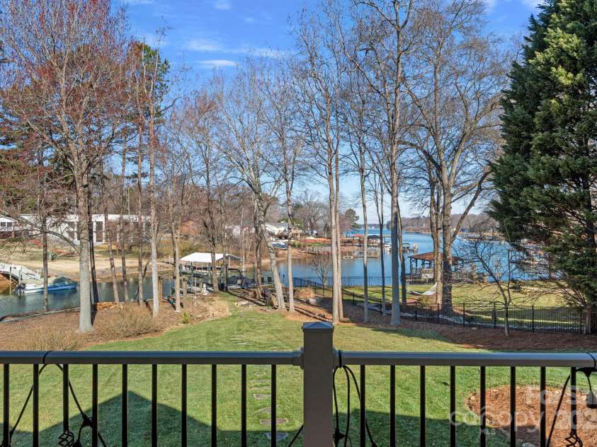 15015 NC Hwy 73 Highway, Huntersville, NC 28078.  MLS# CAR4226627, YatesRealty ID 12520. Covered balcony with lake views, accessed from either living room, dining room, or primary bedroom!