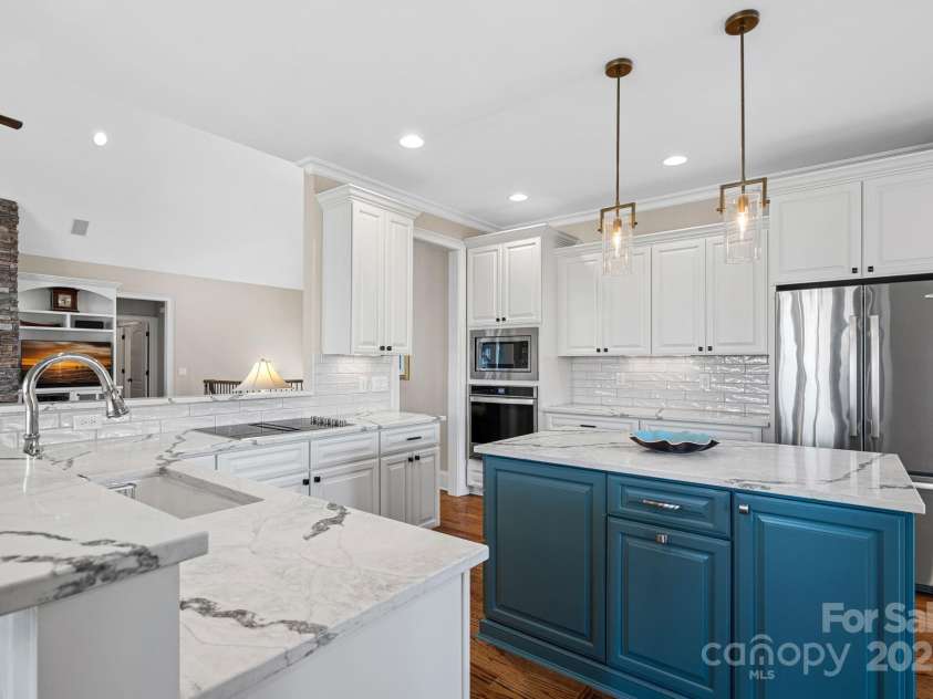 15015 NC Hwy 73 Highway, Huntersville, NC 28078.  MLS# CAR4226627, YatesRealty ID 12520. Newly renovated gourmet kitchen with SS appliances, quartz countertops, large island, and breakfast bar....open to the dining and living areas with lake views!