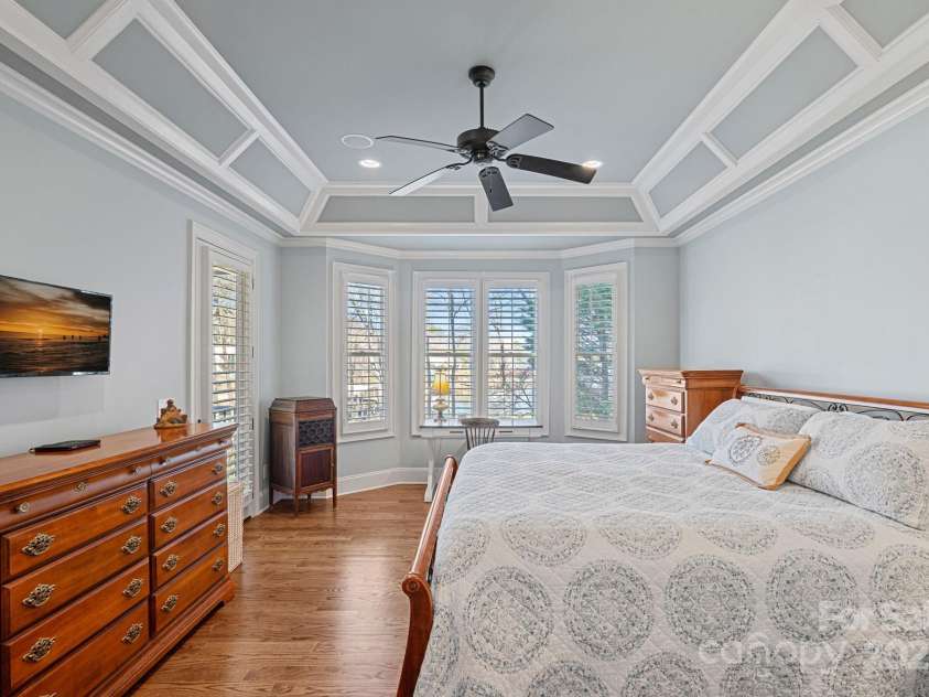 15015 NC Hwy 73 Highway, Huntersville, NC 28078.  MLS# CAR4226627, YatesRealty ID 12520. Primary bedroom with lake views and beautiful, custom architectural details, and access to covered balcony