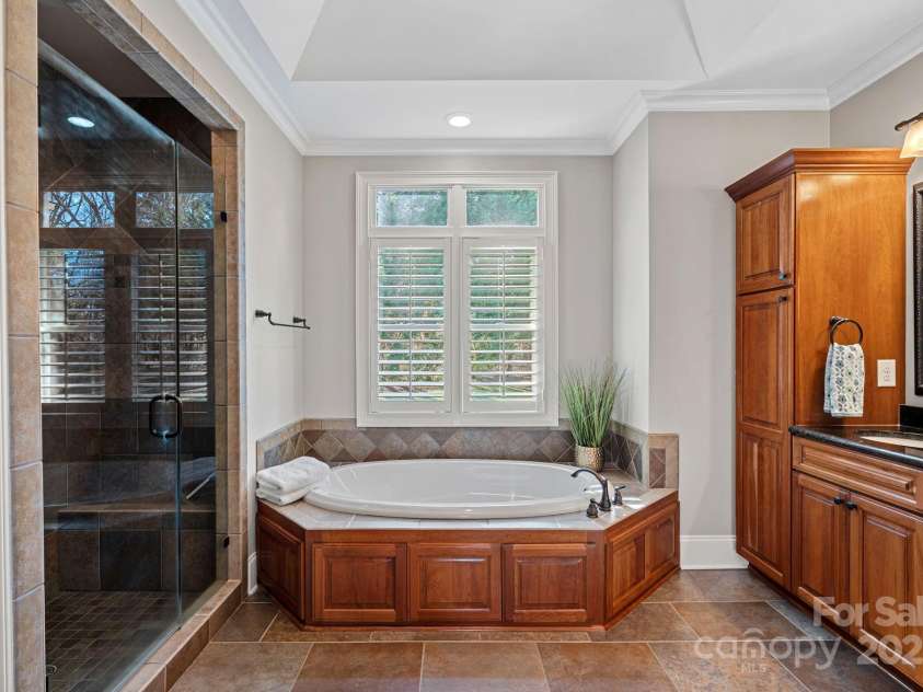15015 NC Hwy 73 Highway, Huntersville, NC 28078.  MLS# CAR4226627, YatesRealty ID 12520. Primary ensuite with large, walk-in shower, garden tub, beautiful custom cabinetry