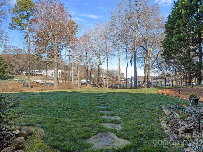 15015 NC Hwy 73 Highway, Huntersville, NC 28078.  MLS# CAR4226627, YatesRealty ID 12520. Stepping-stone pathway to fire pit and floating dock, accessed from walk-out basement