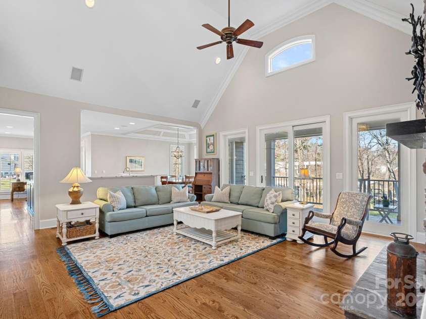 15015 NC Hwy 73 Highway, Huntersville, NC 28078.  MLS# CAR4226627, YatesRealty ID 12520. Stunning living room with vaulted ceiling, full-height stone fireplace, built-ins, and lake views!