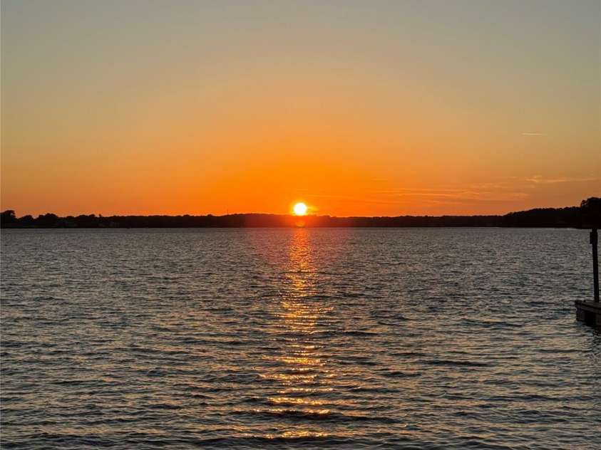 17821 Carlow Road, Cornelius, NC 28031.  MLS# CAR4364716, YatesRealty ID 12527. Clear sky summertime sunset from backyard!