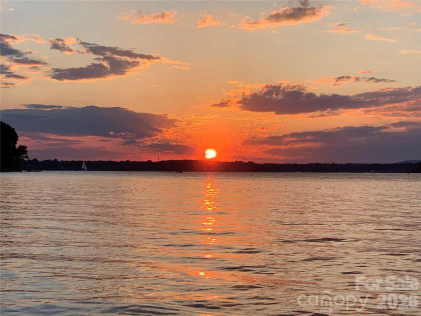 17821 Carlow Road, Cornelius, NC 28031.  MLS# CAR4364716, YatesRealty ID 12527. Summertime sunset from dock!