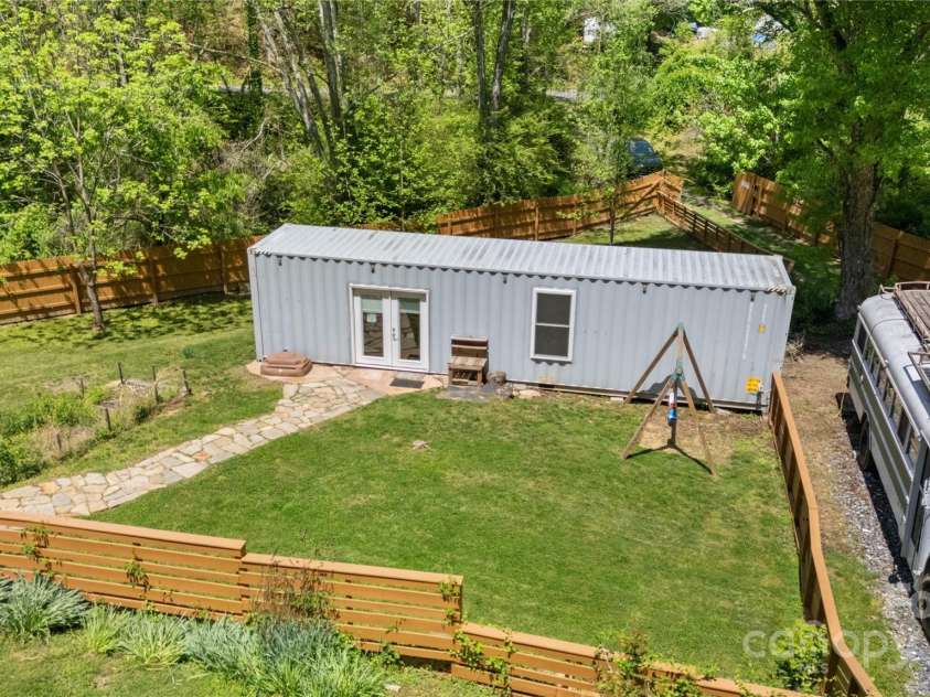 89 Flynn Branch Road, Asheville, NC 28804.  MLS# CAR4198196, YatesRealty ID 12530. Fenced-in level yard at the shipping container