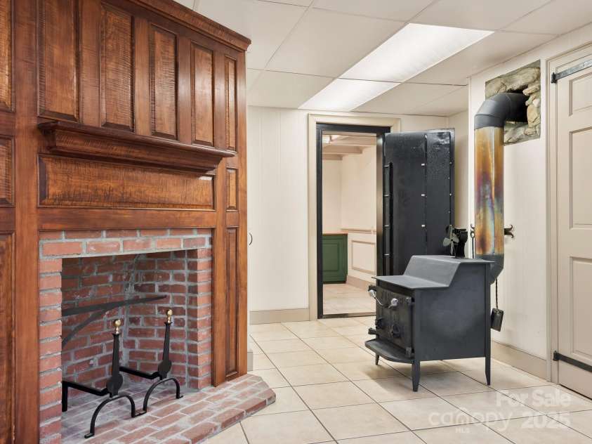 116 Sams Branch Road, Candler, NC 28715.  MLS# CAR4137587, YatesRealty ID 1254. Wood stove, vault, lower fireplace 