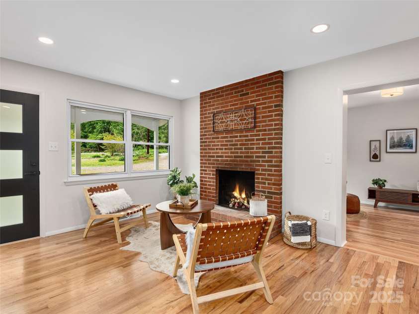 16 Emerson Poore Drive, Candler, NC 28715.  MLS# CAR4256902, YatesRealty ID 12551. Den with fireplace