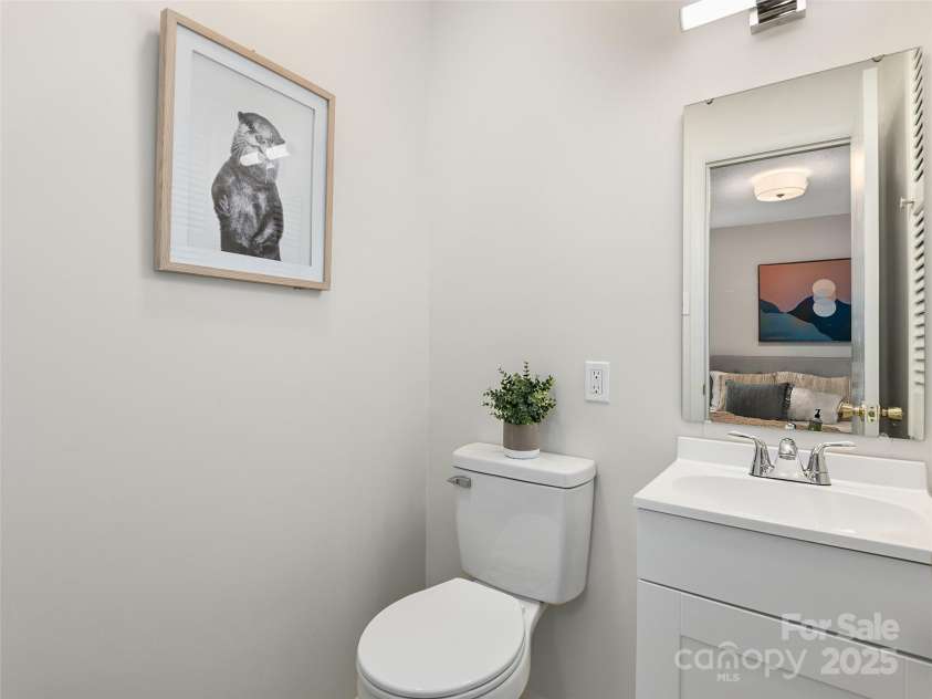 16 Emerson Poore Drive, Candler, NC 28715.  MLS# CAR4256902, YatesRealty ID 12551. Half bath off primary bedroom with tile floors