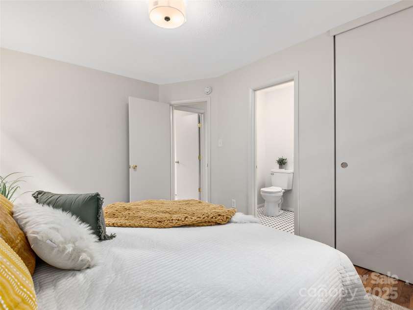 16 Emerson Poore Drive, Candler, NC 28715.  MLS# CAR4256902, YatesRealty ID 12551. Primary bedroom with half bath