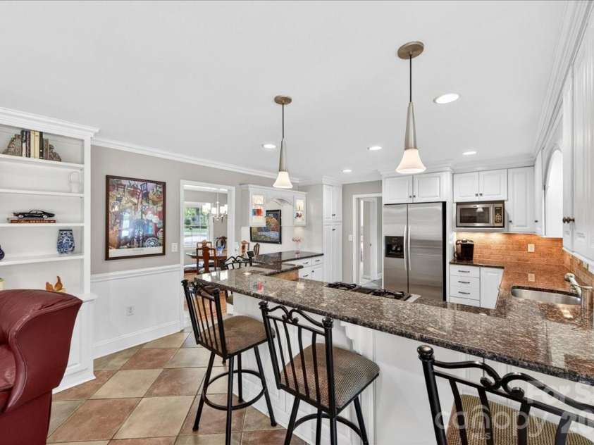 3229 Zelda Lane, Matthews, NC 28105.  MLS# CAR4366492, YatesRealty ID 12580. Eat at Bar in Kitchen 