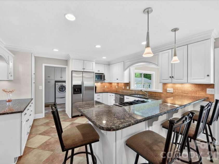 3229 Zelda Lane, Matthews, NC 28105.  MLS# CAR4366492, YatesRealty ID 12580. View of Kitchen from Den