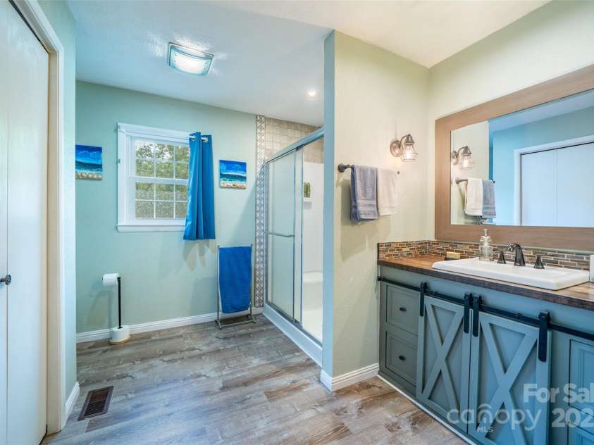 381 Old Mars Hill Highway, Weaverville, NC 28787.  MLS# CAR4255110, YatesRealty ID 12585. Spacious Bathroom with Laundry Closet