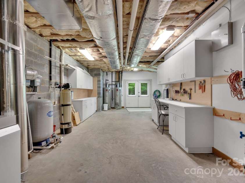 721 Lakeside Drive, Lake Toxaway, NC 28747.  MLS# CAR4240541, YatesRealty ID 1259. Huge utility room with workshop. 