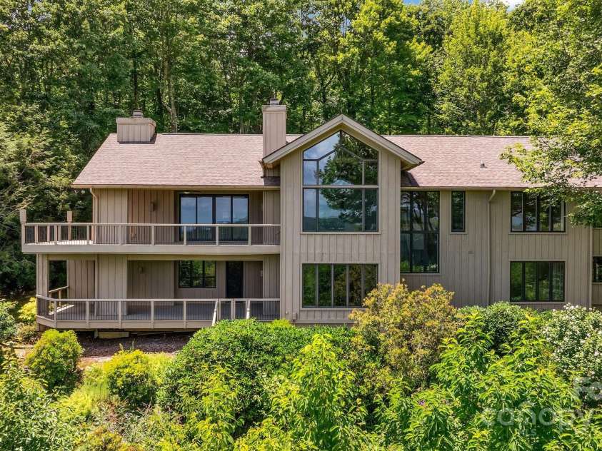 721 Lakeside Drive, Lake Toxaway, NC 28747.  MLS# CAR4240541, YatesRealty ID 1259. Rear of home facing view of lake & mountains