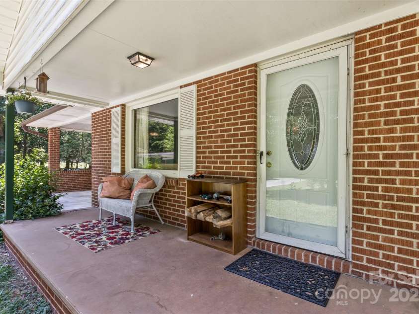117 White Pine Lane, Morganton, NC 28655.  MLS# CAR4246633, YatesRealty ID 12597. Rocking chair front porch overlooks front yard.