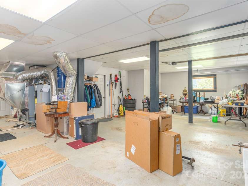 806 Twin Brook Drive, Waynesville, NC 28785.  MLS# CAR4254355, YatesRealty ID 12634. Large basement area with 2 car garage and workshop area